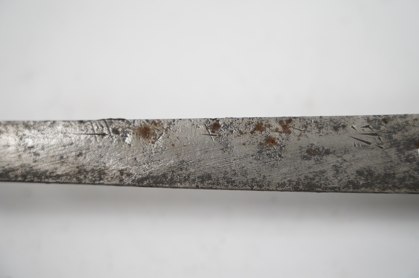 A Japanese WWII army officer’s sword Katana, blade 57.9cm, signed and dated with Seki Arsenal stamp, retaining good polish, in shin gunto mounts with leather combat cover on hilt and scabbard, the latter with plate stamp